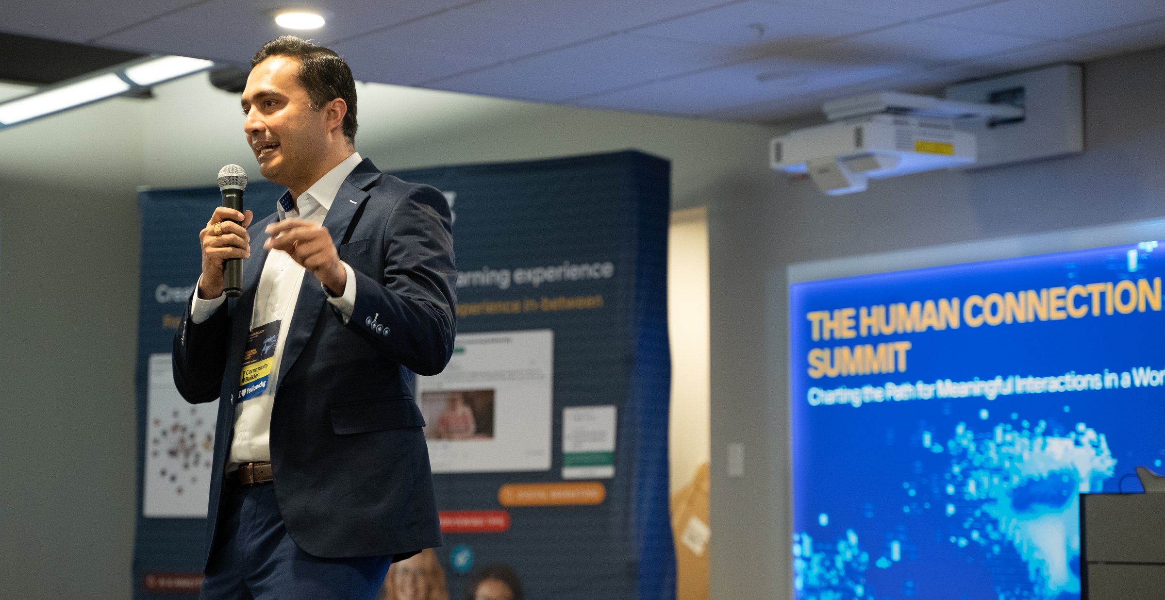 Shaunak Roy speaking at the Yellowdig Human Connection Summit, with the summit title displayed on screen behind him.